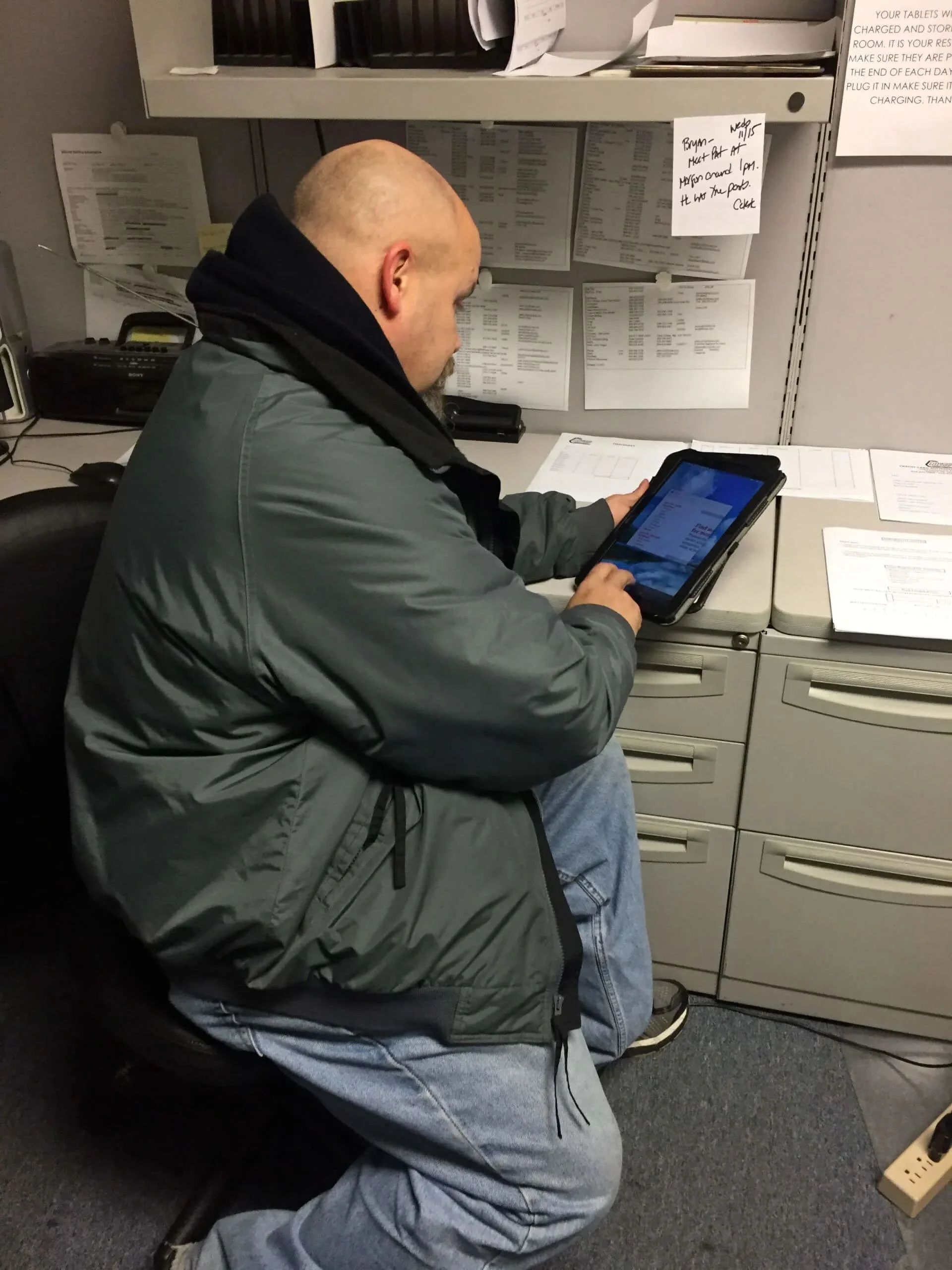 Bryan looking at the tablet for jobs for the day